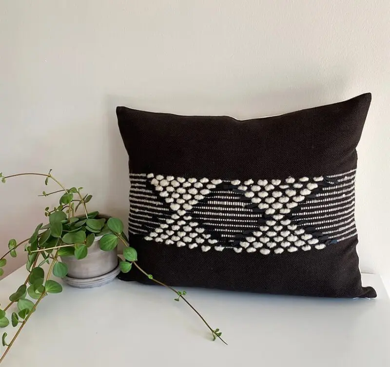 Black Moroccan handmade cushion cover with white stripes and wool decorations