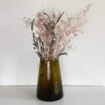 Moroccan hand-blown vase in brown with flowers in it
