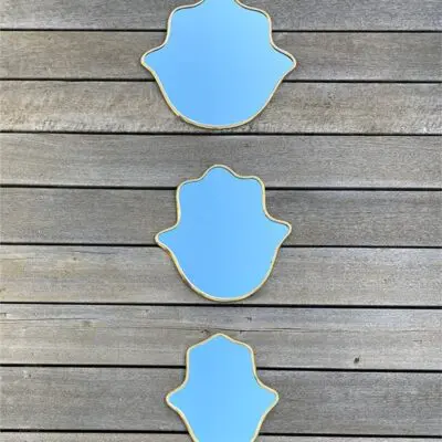 Moroccan handmade mirrors with gold edges shaped like Fatima's hand in three different sizes