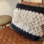 Moroccan handwoven kesh cushion cover in black and white lying on chair