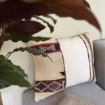 Handwoven vintage kilim ourika cushion cover on the corner of a sofa