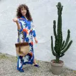 Model in Moroccan handwoven dress with lotus flower pattern in blue tones