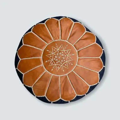 Round hand-stitched denim pouf with leather Moroccan pattern on top, from above