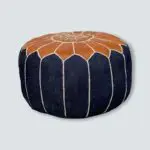 Round hand-stitched denim pouf with leather Moroccan pattern on the top, from the side
