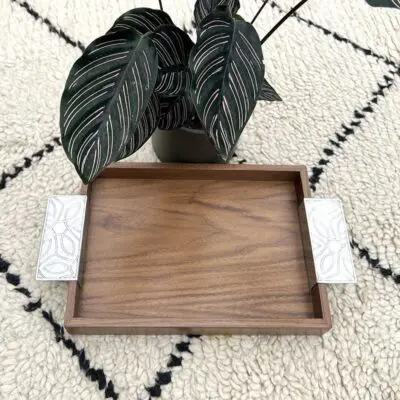 Moroccan handmade tray in walnut wood with inox handle next to plant