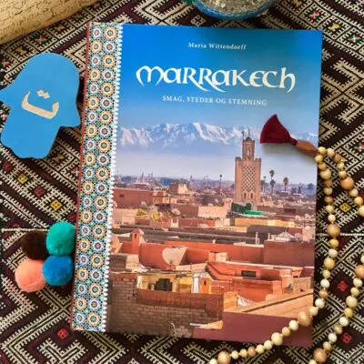 Marrakesh. Taste, places and atmosphere book on top of a Moroccan rug