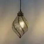 Moroccan handmade twisting drop-shaped lamp, lit in the dark