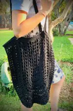 Model holding crochet net in black