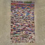 Moroccan handwoven Boucherouite rug with tassels on the sides in a multicolored pattern