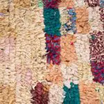 Handwoven boucherouite rug in multicolored pattern with beige tones, dense