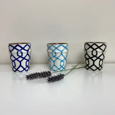 three Moroccan handmade mugs in white with striped pattern in blue, light blue and black