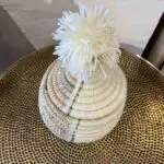 Small Moroccan handmade basket in natural rattan and white with tassel on top of the lid, from above