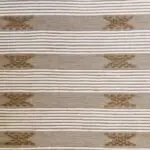 Handwoven cotton rug in beige with Moroccan stripe and dot pattern in shades of brown, dense