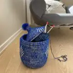 Moroccan handmade basket in blue with gold threads with knitted items in it