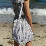 Model holding crochet net in white