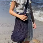 Model holding crochet net in blue