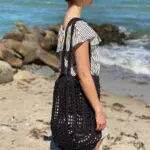 Model holding crochet net in black