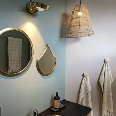 Moroccan handmade raffia basket lamp hanging in a bathroom