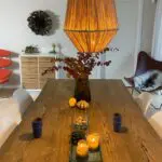 Moroccan handmade raffia lamp in cone shape, hanging above a dining table