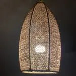 Moroccan handmade cylindrical rattan lamp, lit in the dark
