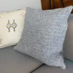 Moroccan handmade wool pillow on a sofa with other pillows