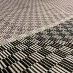 Moroccan handwoven bedspread with white and black square pattern, dense