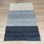 Moroccan handwoven carpet in shades of gray and beige with wool details