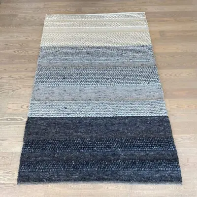 Moroccan handwoven carpet in shades of gray and beige with wool details