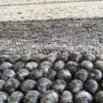 Moroccan handwoven rug in shades of gray and beige with wool details, dense