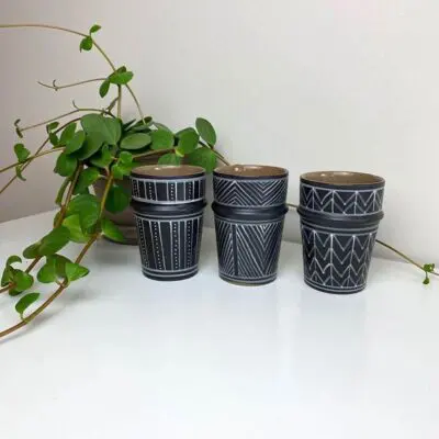 Three Moroccan handmade beldi mugs in black with different white patterns