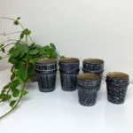 Five Moroccan handmade beldi mugs in black with different white patterns