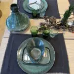 Marokkanische handbestickte Tischsets auf einem fein gedeckten Tisch, gefüllt mit Steinzeuggeschirr und Beldi-Gläsern