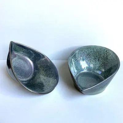 Four Moroccan handmade stoneware bowls that are shaped like a drop