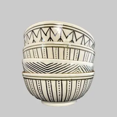 Moroccan handmade bowls in white with black patterns standing on top of each other