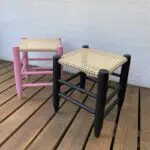 Moroccan handmade stools in black and pink standing next to each other