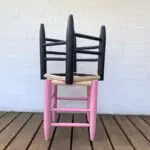 Moroccan handmade stools in black and pink, stacked on top of each other