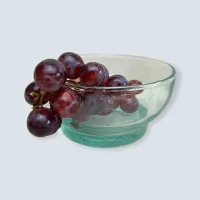 Large handmade transparent beldi glass bowl with grapes inside