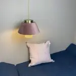 Moroccan handmade pendant lamp in pink velour, hanging in a cozy corner with a sofa bench and pink pillow