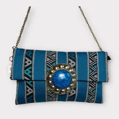 handbag in patterned blue fabric with internal zip and copper chain