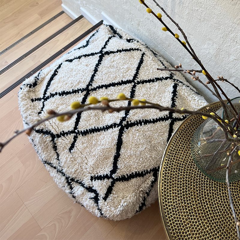 Firkantet marokkansk håndsyet gulvpude i uld med sort diamantmønster i stue fra oven