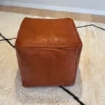 Moroccan pouf in leather. square- reddish brown