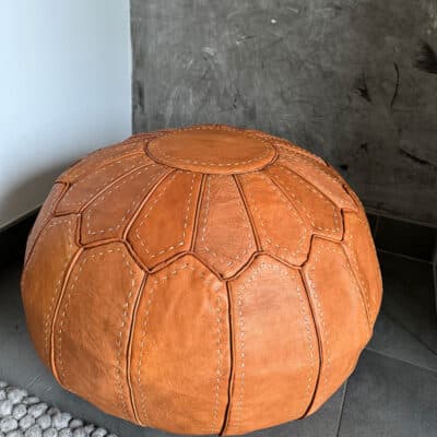 Light brown pouf with white stitches