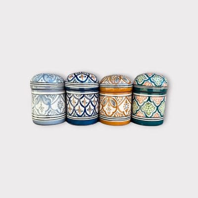 Magnifiques pots en céramique marocaine. Disponibles en 4 variétés, chacune avec son propre motif marocain traditionnel. Dimensions : 13 cm de hauteur et 9 cm de diamètre. Couvercle rond. Fabriqués à la main au Maroc.