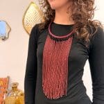 Collier de perles rouge bordeaux avec un collier tressé de la même couleur.