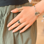 unik ring der viser to hænder der holder om et sort hjerte med en krone på.