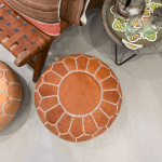 Pouf en cuir de chèvre marron clair.
