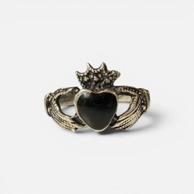 unik ring der viser to hænder der holder om et sort hjerte med en krone på.
