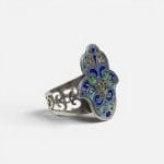 Beautiful silver ring with enamel details in beautiful colors. The ring is handmade and shaped like the hand of Fatima.