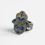 Beautiful silver ring with enamel details in beautiful colors. The ring is handmade and shaped like the hand of Fatima.