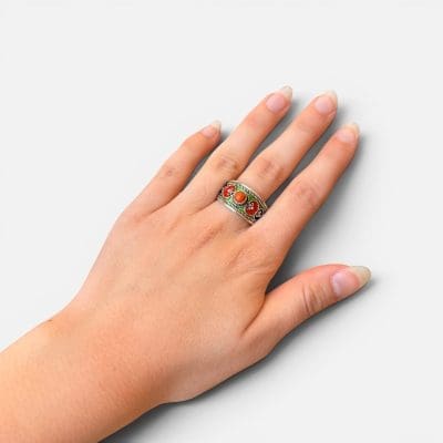 Beautiful silver ring in enamel in green, red, orange and blue colors. Reddish orange stone in the center.